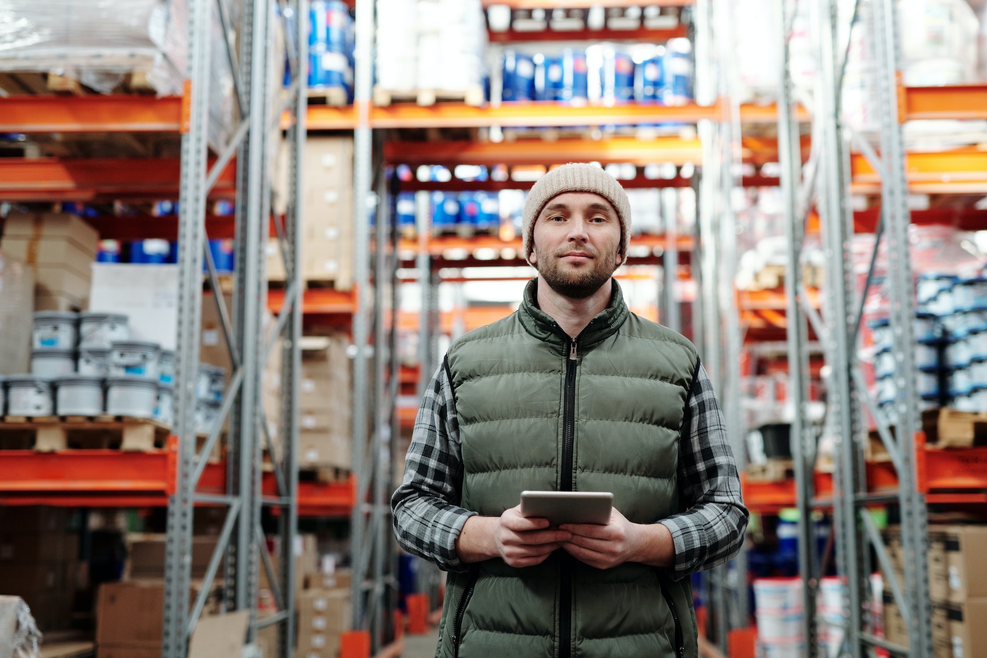 a man holding a tablet in a storage house