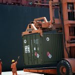 Dockworker and cargo containers