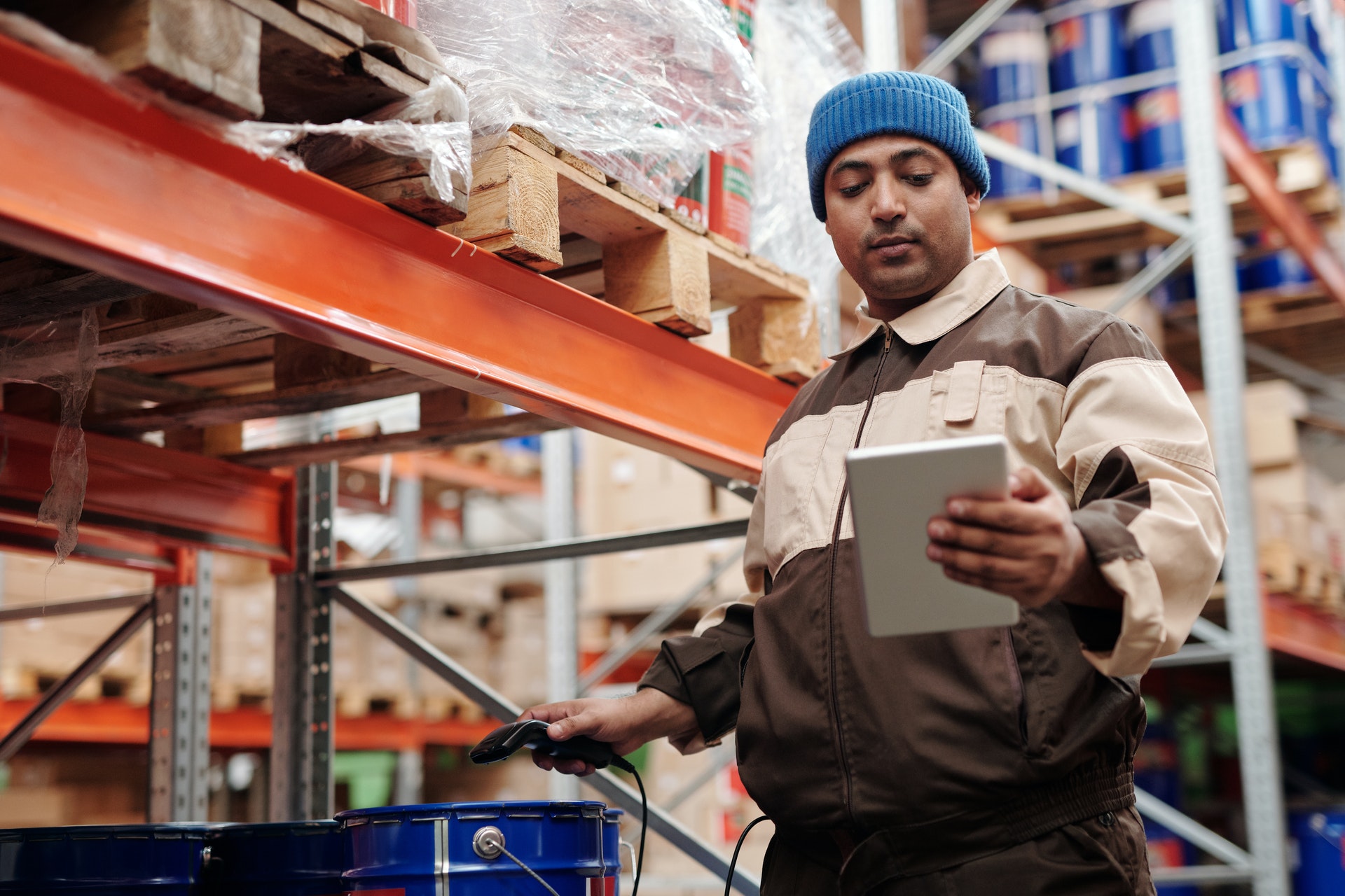 A warehouse worker checking supply chain information representing the common challenges of omnichannel logistics.
