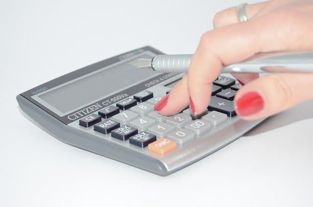 Woman using calculator.