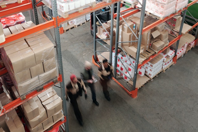 three men in a warehouse managing warehouse