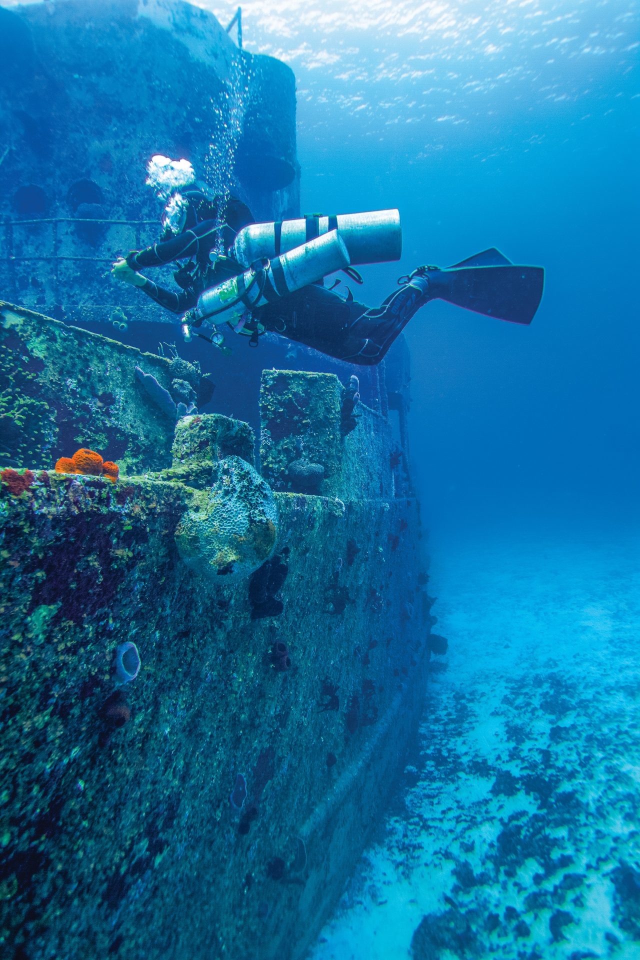 scuba diver exploring sunken ship