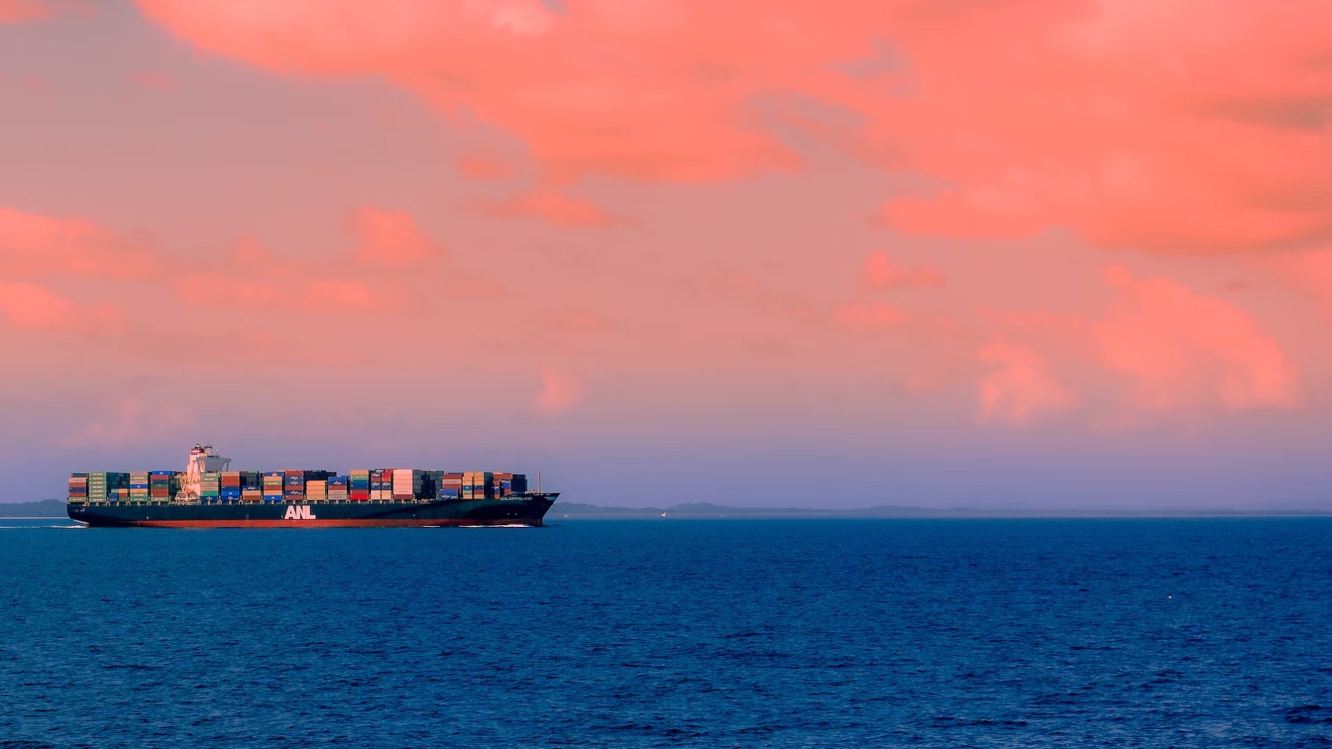 A large container ship at sea, exemplifying the evolution of container ship design over the years.