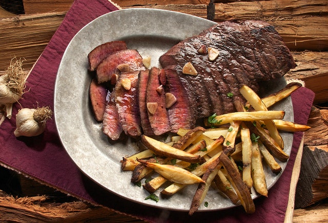 A steak served with French fries.