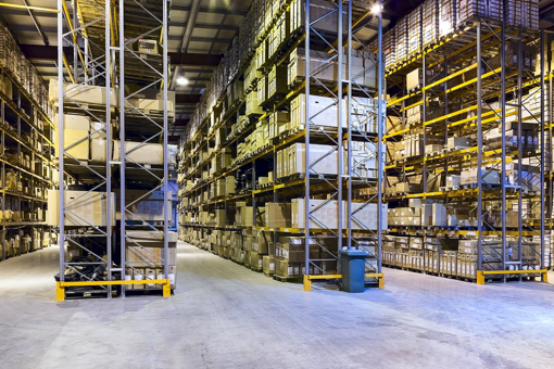 Boxes stacked on floor-to-ceiling metal shelves in a warehouse